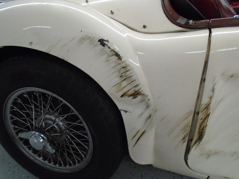 Scratched and dirty classic car fender.