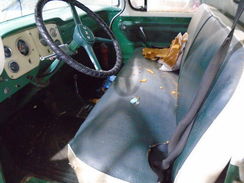 Green GMC truck interior, dirty seat.