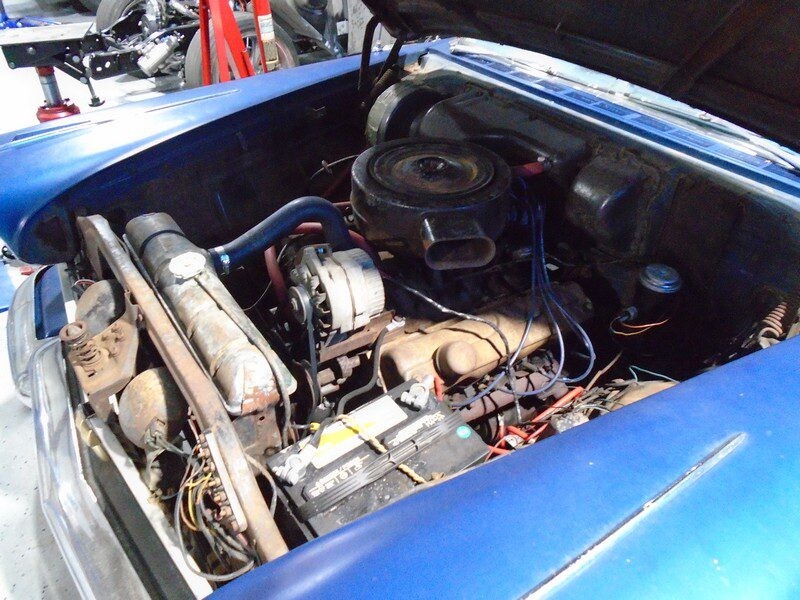 Open hood, vintage car engine bay.