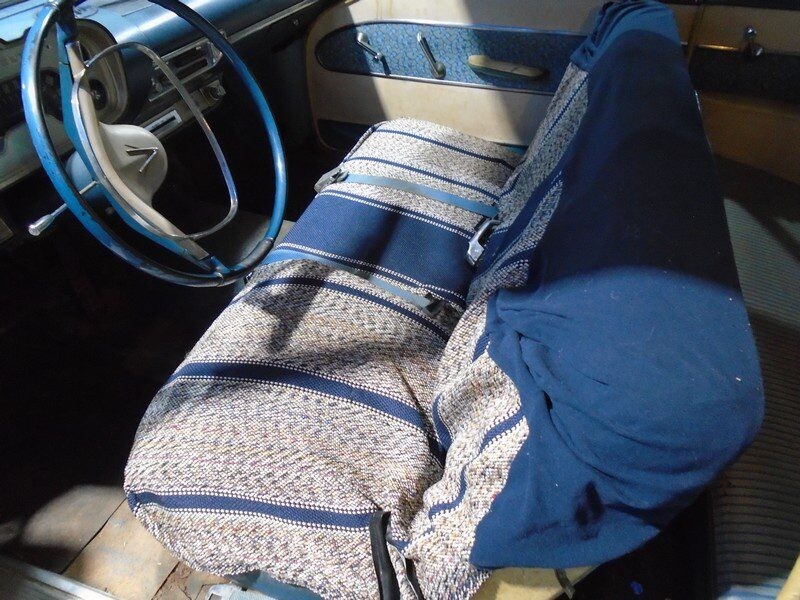 Classic car interior, blue patterned seats.