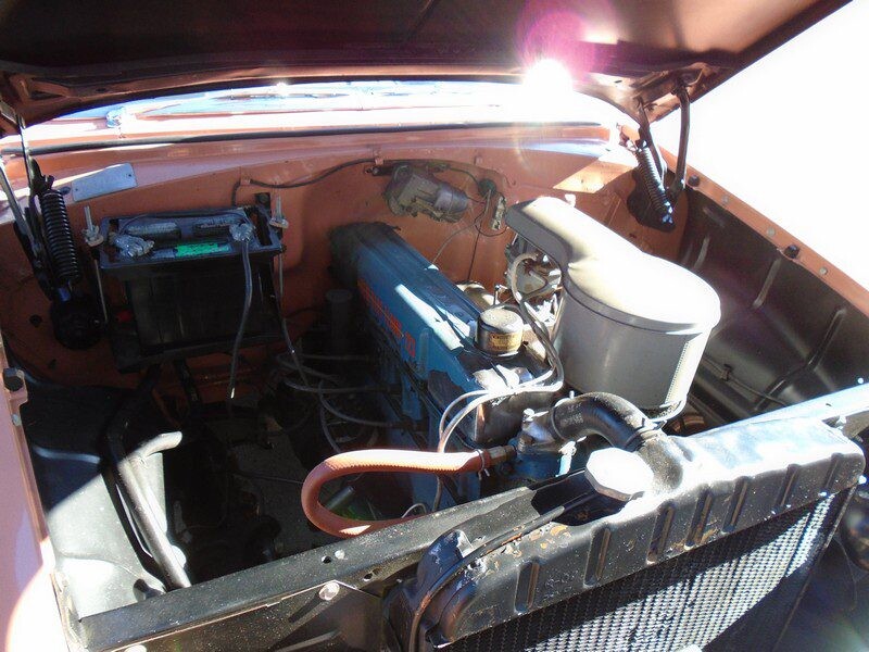 Orange firewall with blue inline six engine