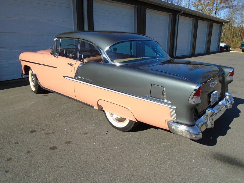 1955 Chevrolet Bel Air in gray and light brown color outside a garage